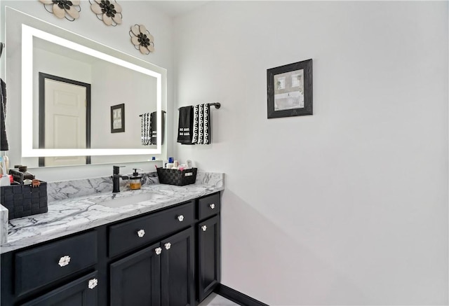 bathroom featuring vanity and baseboards