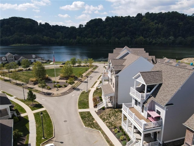 bird's eye view with a water view and a wooded view