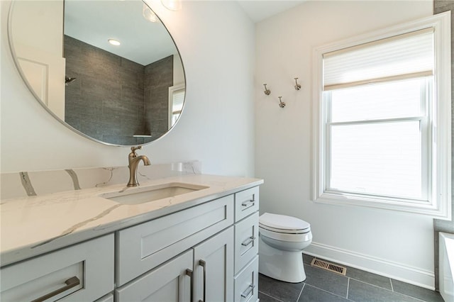 bathroom featuring baseboards, visible vents, toilet, tile patterned flooring, and vanity