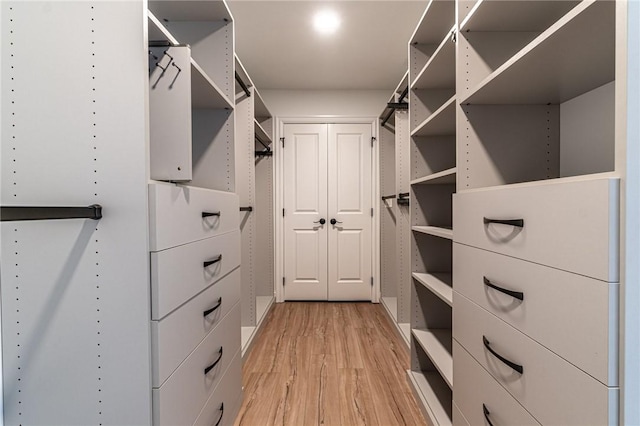 walk in closet featuring light wood-style flooring