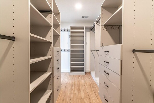 walk in closet with light wood-style floors and visible vents