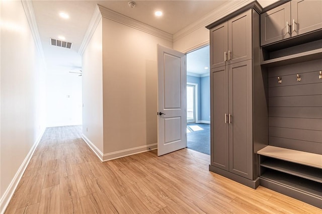 mudroom featuring ornamental molding, visible vents, light wood-style flooring, and baseboards