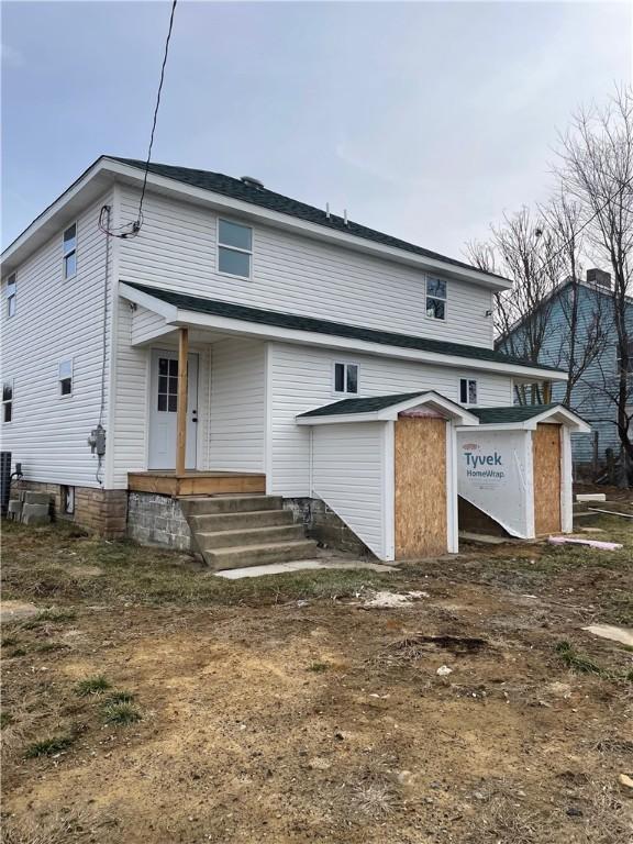 back of property featuring cooling unit