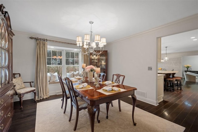 dining room featuring an inviting chandelier, baseboards, dark wood-style floors, and crown molding