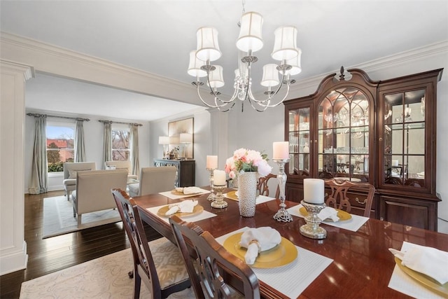 dining room with ornamental molding, wood finished floors, and an inviting chandelier