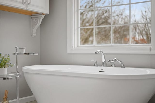 bathroom featuring a soaking tub