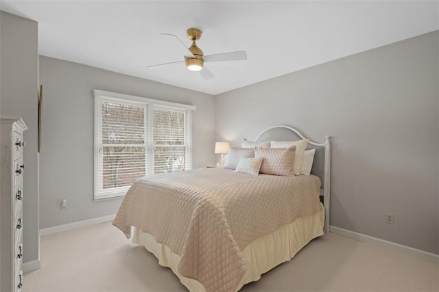 bedroom featuring baseboards, ceiling fan, and light colored carpet