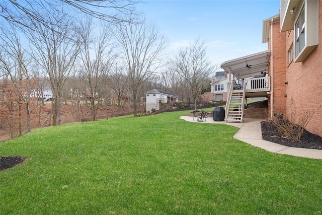 view of yard featuring a patio, stairway, and a ceiling fan