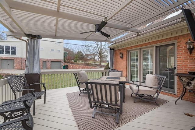 wooden terrace featuring a ceiling fan and a pergola