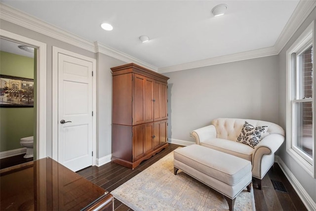 living area featuring baseboards, ornamental molding, dark wood-style flooring, and a healthy amount of sunlight