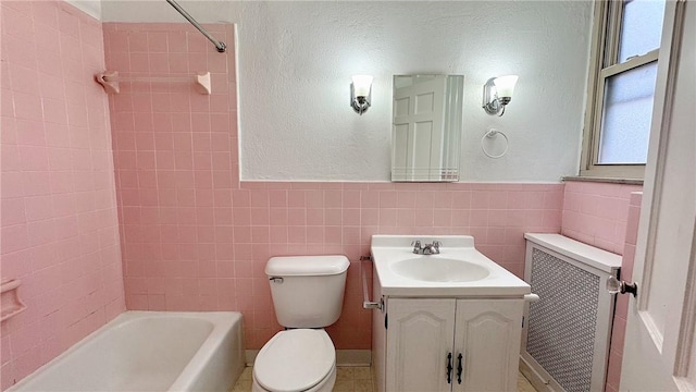 bathroom with toilet, radiator, tub / shower combination, and tile walls