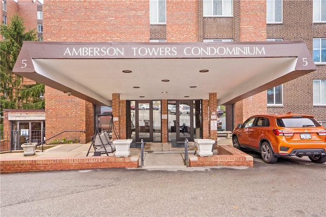 view of exterior entry with brick siding