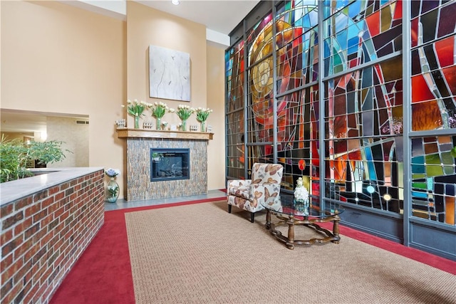 sitting room with a tile fireplace