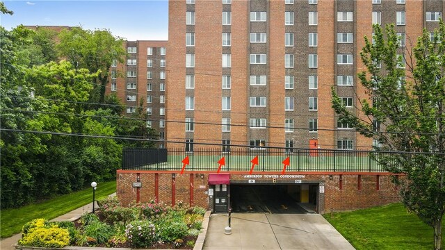 5 Bayard Rd Unit 113, Shadyside, PA 15213 - view of building exterior featuring driveway, fence, and a garage