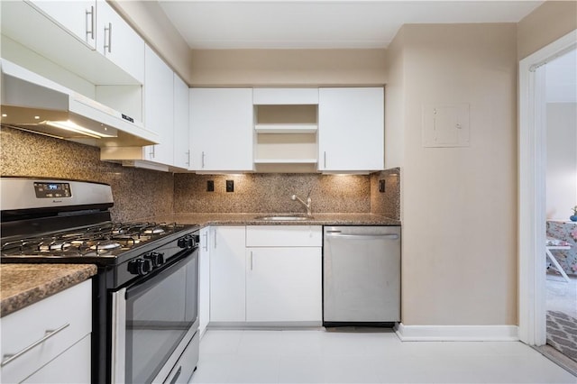 kitchen with backsplash, appliances with stainless steel finishes, open shelves, and a sink