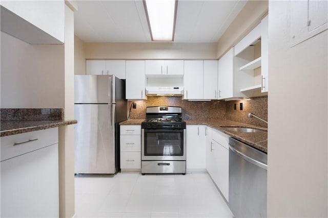 kitchen with under cabinet range hood, stainless steel appliances, a sink, white cabinetry, and open shelves