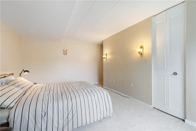 bedroom featuring light carpet and baseboards