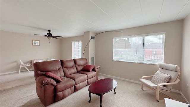 living room featuring ceiling fan, baseboards, and carpet flooring