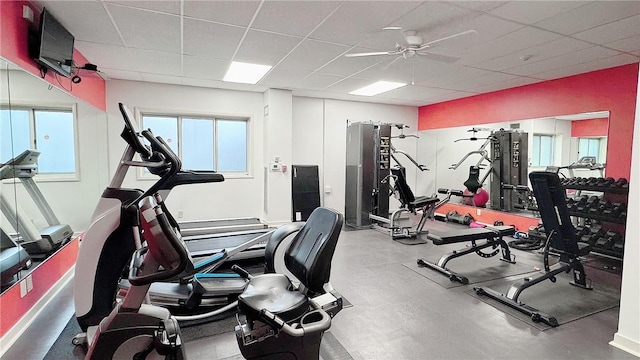 gym featuring a paneled ceiling and ceiling fan