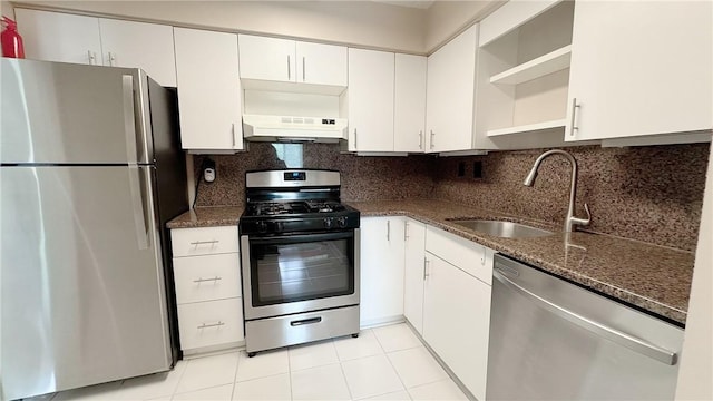 kitchen featuring a sink, dark stone counters, open shelves, stainless steel appliances, and under cabinet range hood