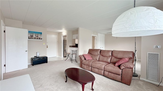 living room featuring light carpet, baseboards, and visible vents