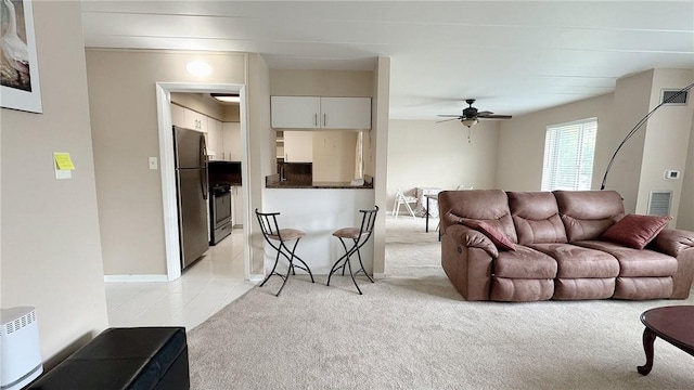 living room with light carpet, a ceiling fan, and visible vents
