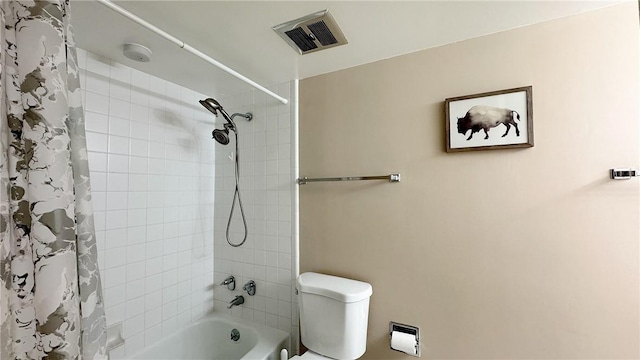 bathroom featuring toilet, visible vents, and shower / bathtub combination with curtain