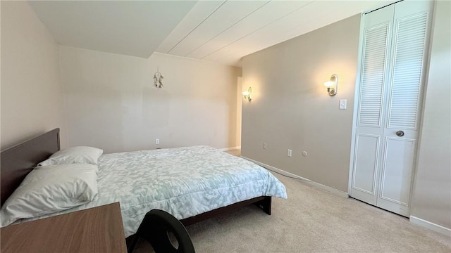 bedroom featuring light colored carpet and baseboards
