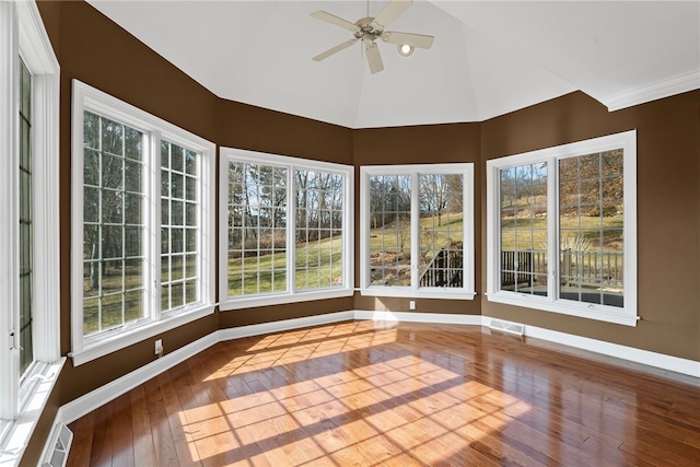 unfurnished sunroom with lofted ceiling, visible vents, and a ceiling fan