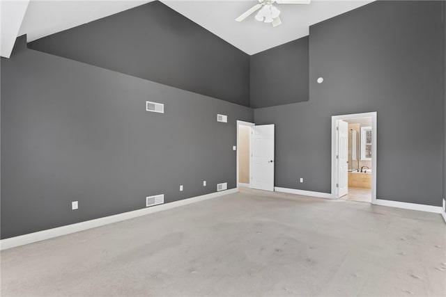 empty room with high vaulted ceiling, baseboards, visible vents, and a ceiling fan