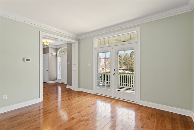 entryway featuring light wood-type flooring, baseboards, and crown molding