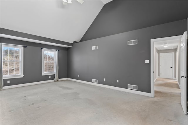 unfurnished room featuring carpet flooring, visible vents, and attic access