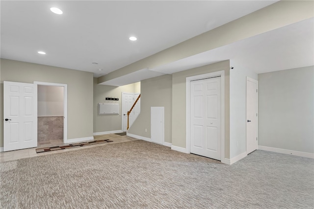 finished below grade area with stairs, carpet, baseboards, and recessed lighting