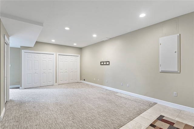 basement with light carpet, baseboards, and recessed lighting