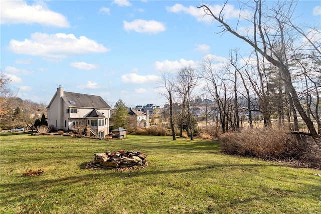 view of yard with an outdoor fire pit and a wooden deck