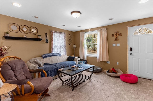 living area featuring baseboards