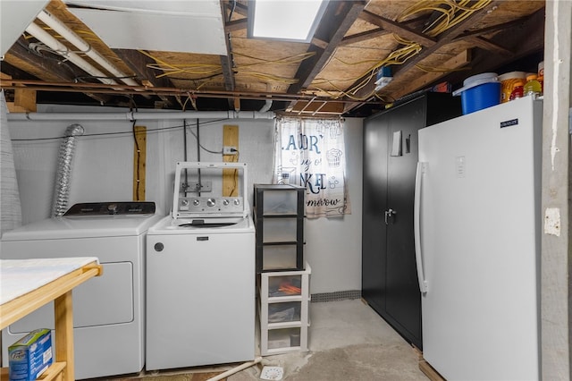 clothes washing area featuring laundry area and washing machine and clothes dryer