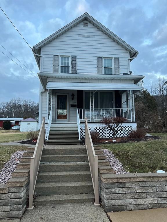 view of front of property with a porch and stairway