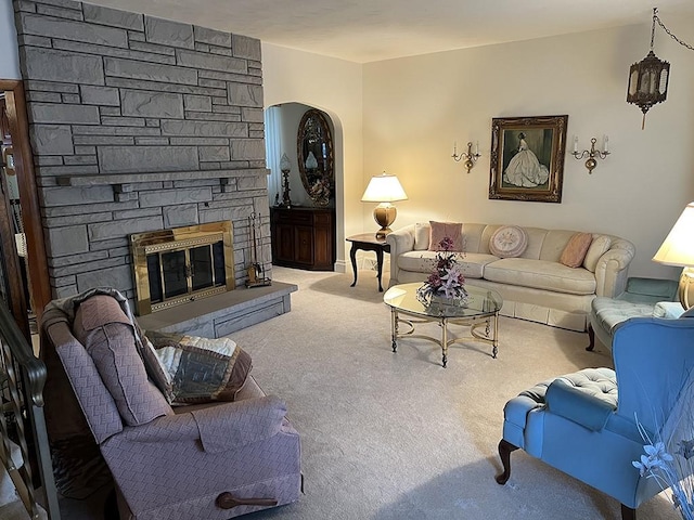 carpeted living area with a fireplace