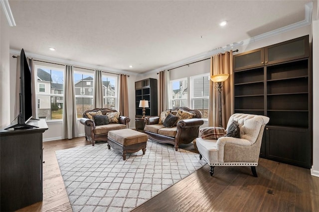 living room with ornamental molding, recessed lighting, and wood finished floors