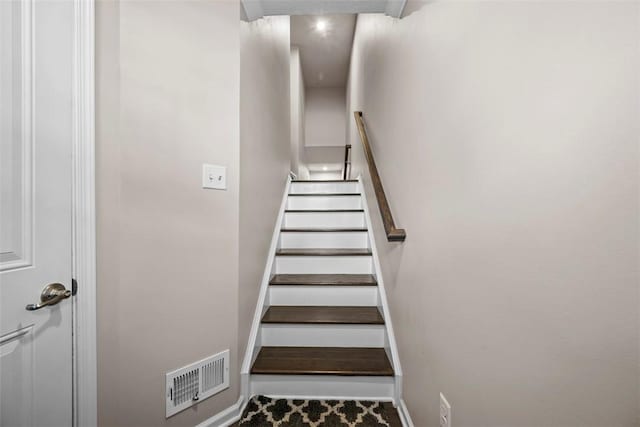 stairway with visible vents and baseboards