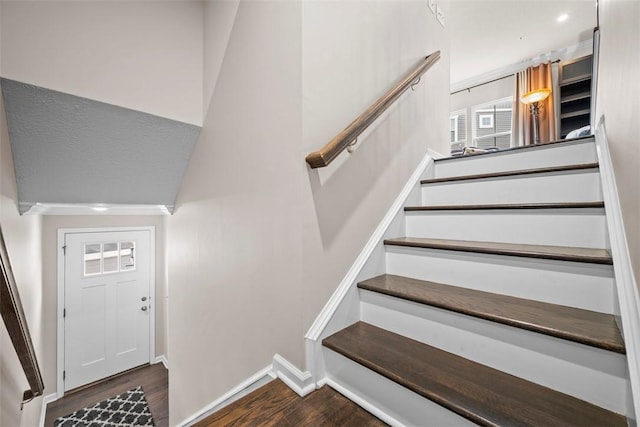 stairway with baseboards and wood finished floors