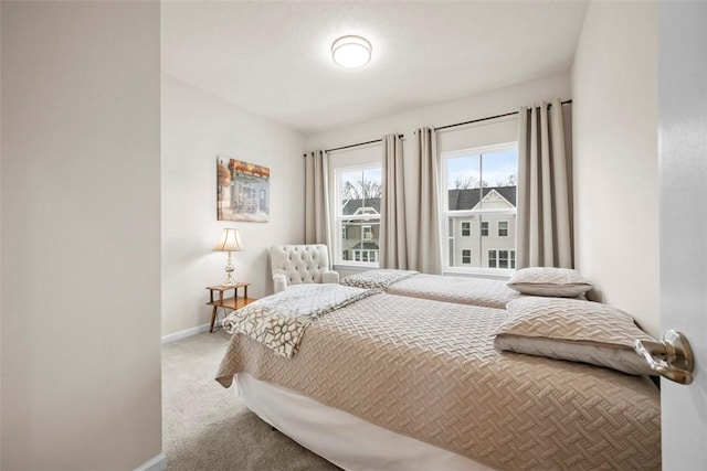 bedroom with baseboards and carpet flooring