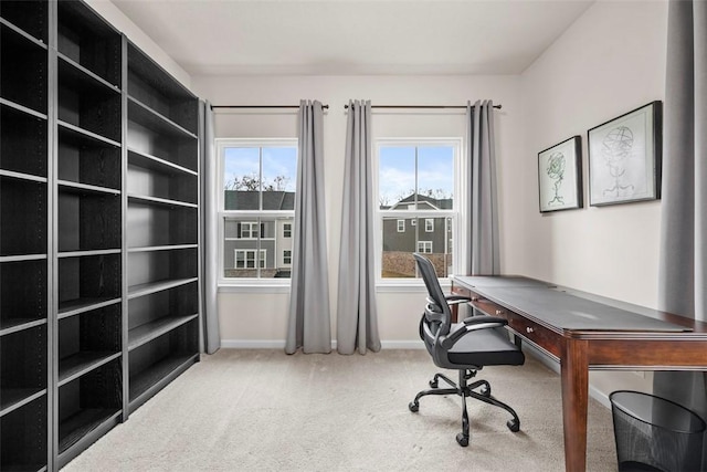 carpeted office space featuring baseboards