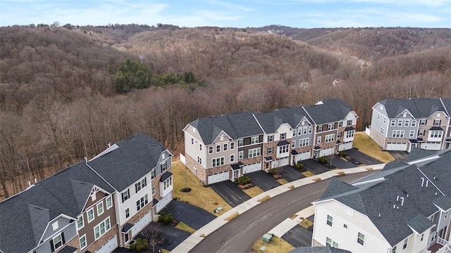 drone / aerial view with a residential view and a view of trees