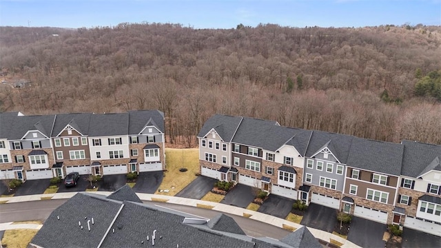 aerial view with a wooded view and a residential view