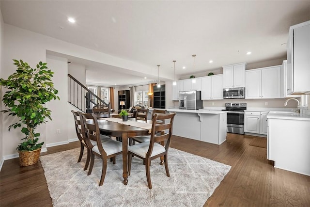 dining area featuring stairs, baseboards, dark wood finished floors, and recessed lighting