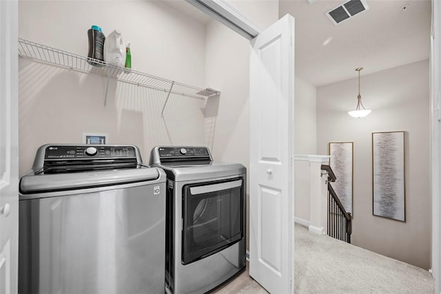 laundry area featuring light carpet, laundry area, washing machine and dryer, and visible vents