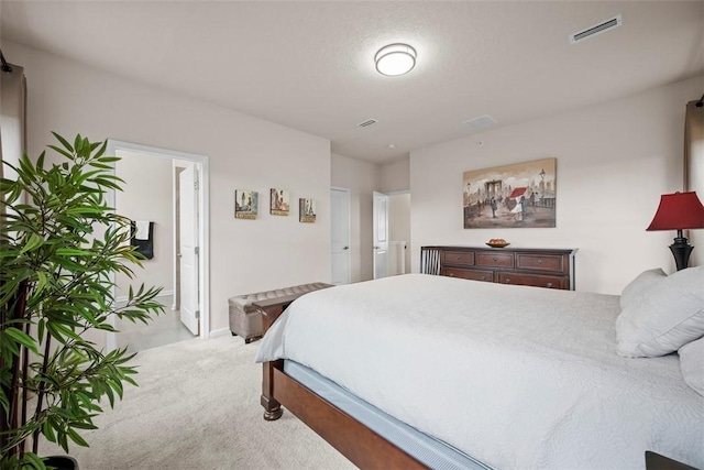 carpeted bedroom featuring visible vents