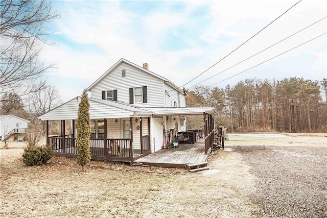 back of property with a chimney